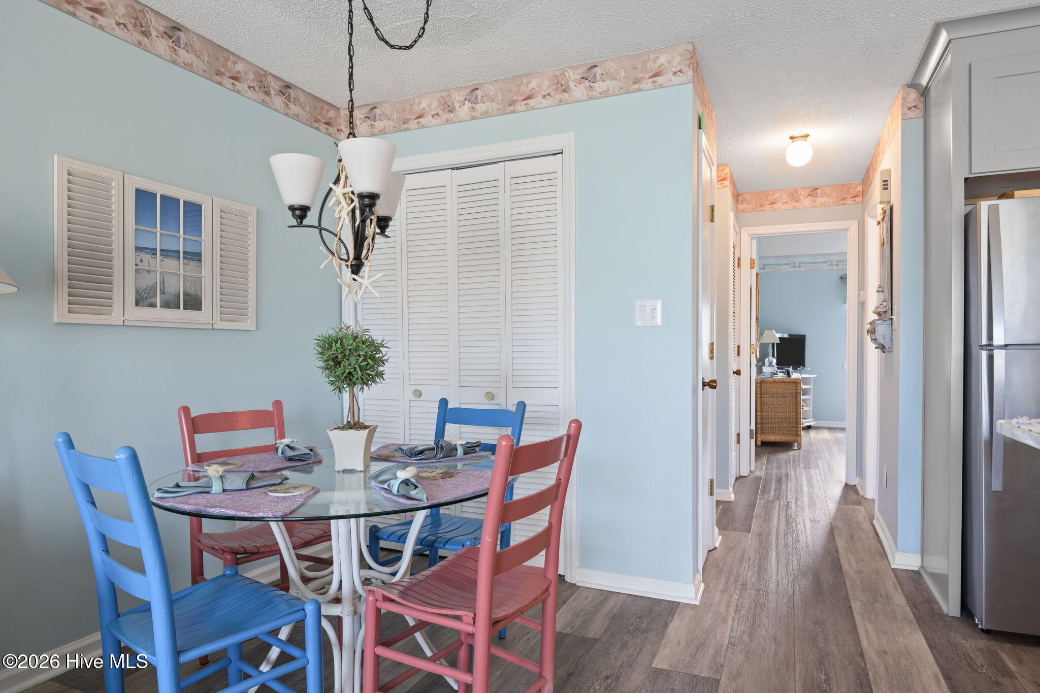 9201 Coast Guard Road, Unit I207 Emerald Isle, NC 28594 - Photo 10 of 26 Dining area with coastal-inspired finishes and easy access to the kitchen and hallway. Compact layout offers comfortable everyday dining space.