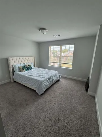 a bed sitting in a room next to a window