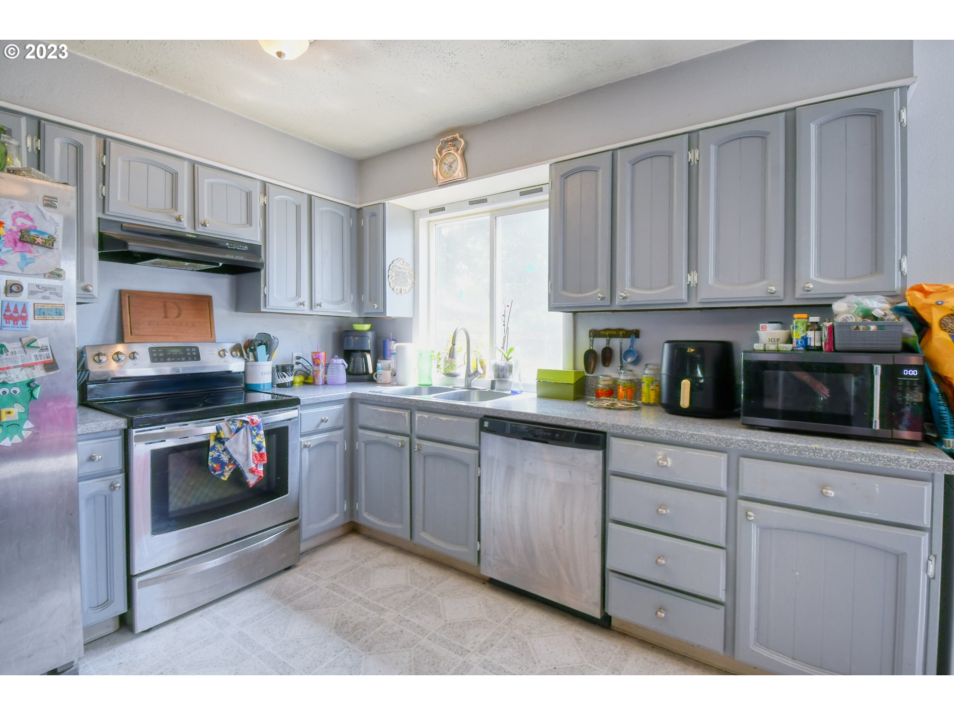3032 Southwest Isaac Avenue Pendleton, OR 97801 - Photo 14 of 30 a kitchen with granite countertop a sink cabinets stainless steel appliances and a window
