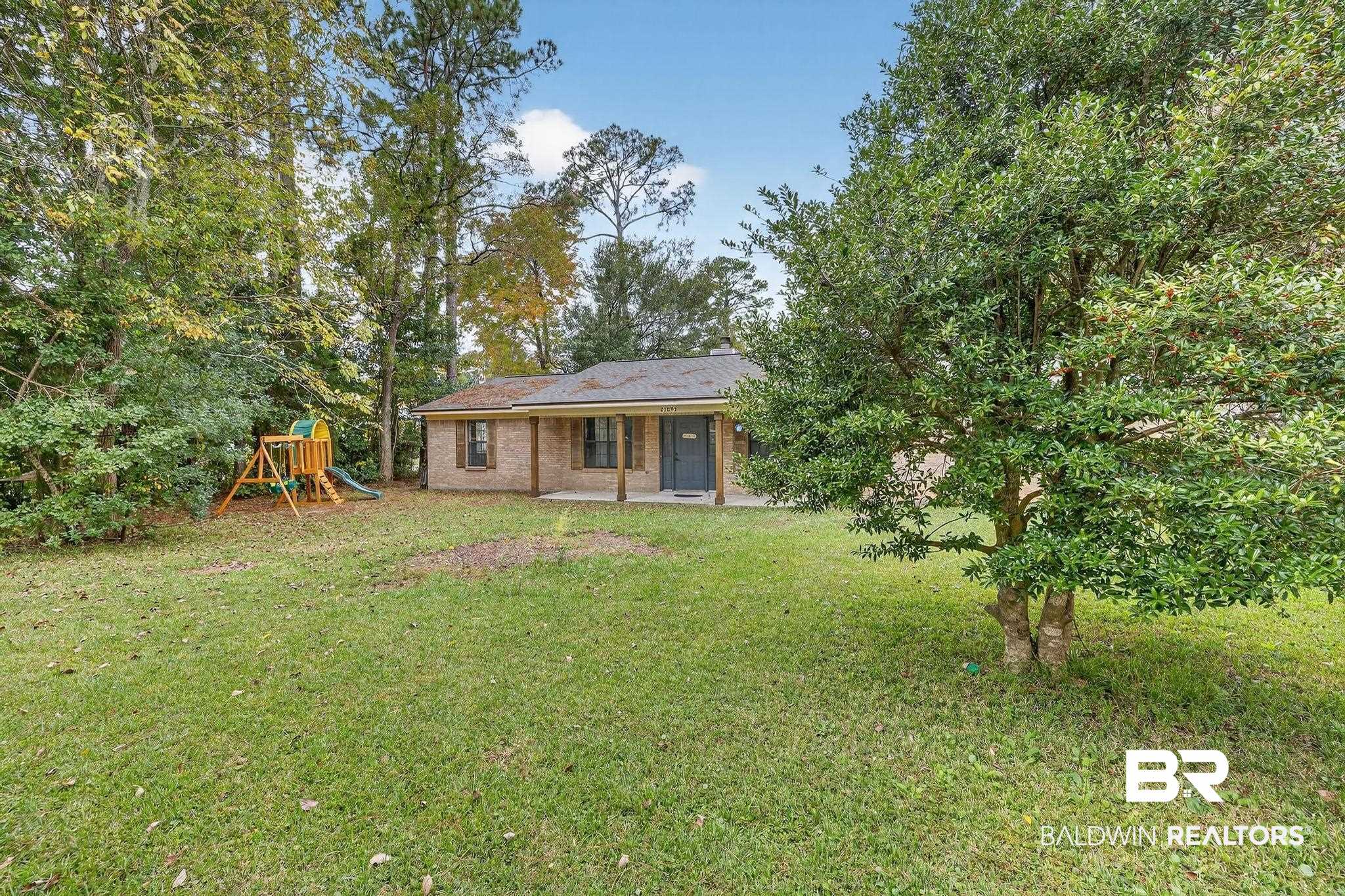 21895 2nd Street Silverhill, AL 36576 - Photo 6 of 43 Front of house with a playground, a patio area, brick siding, and a yard