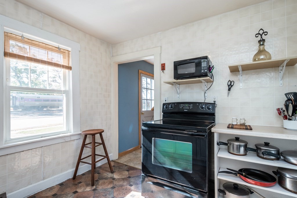 56 Ayer Road Shirley, MA 01464 - Photo 19 of 41 a kitchen with a stove and a microwave