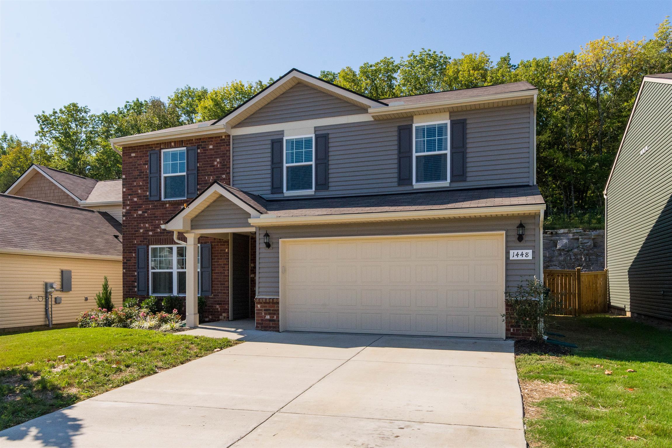 1448 Old Stone Road Lebanon, TN 37087 - Photo 1 of 25 a front view of a house with a yard and garage