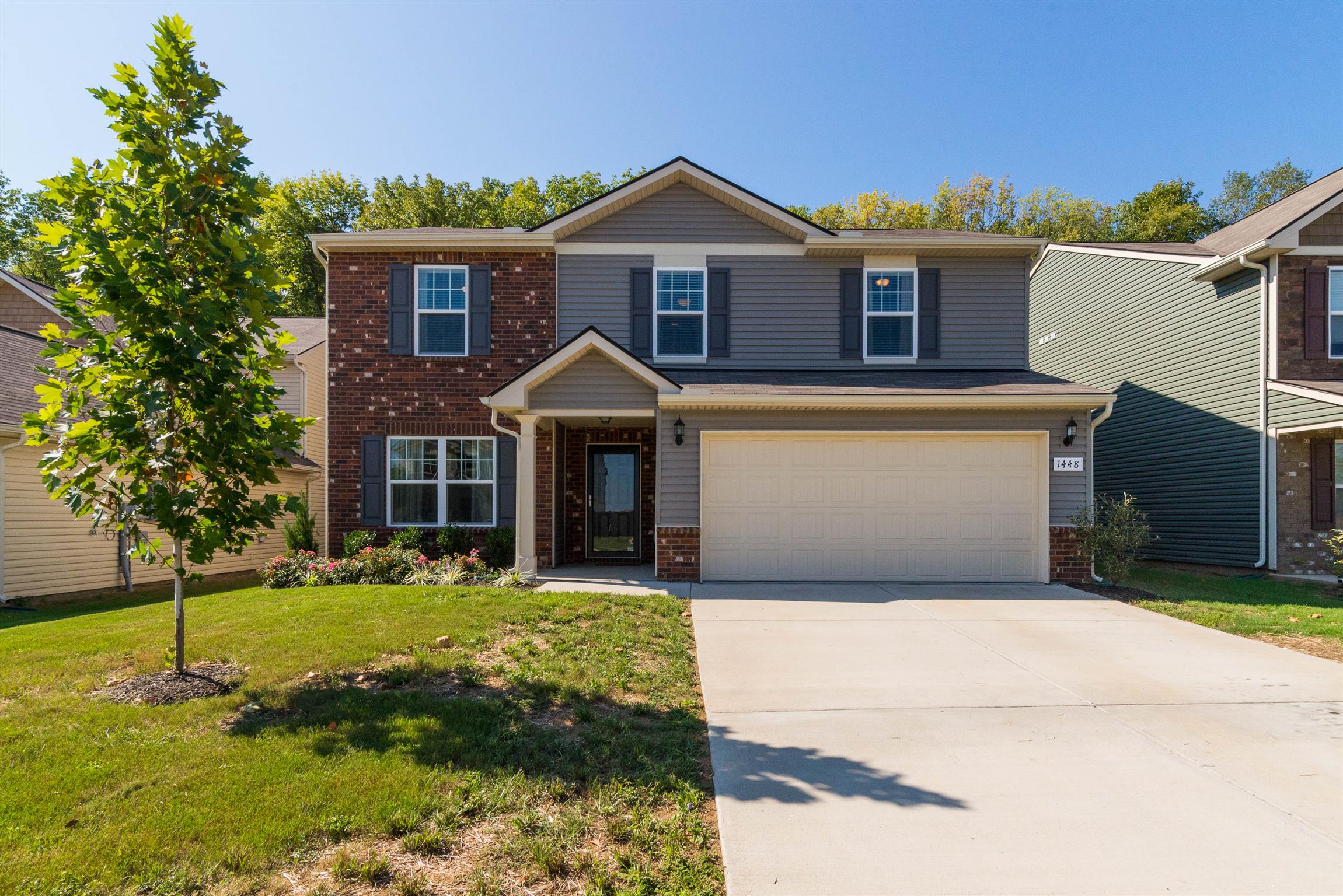 1448 Old Stone Road Lebanon, TN 37087 - Photo 2 of 25 a front view of a house with a yard and garage