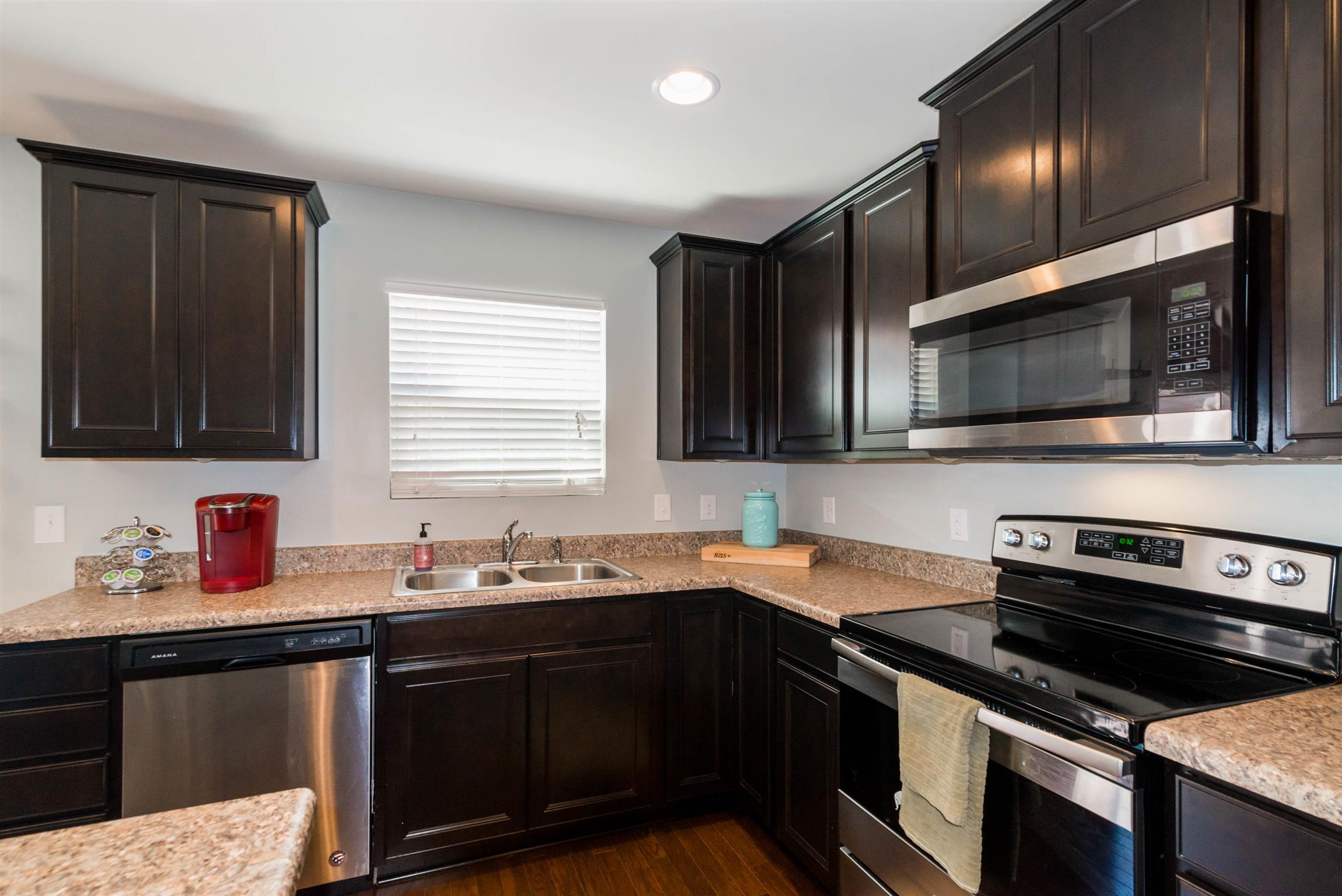 1448 Old Stone Road Lebanon, TN 37087 - Photo 12 of 25 a kitchen with granite countertop a sink stainless steel appliances and cabinets