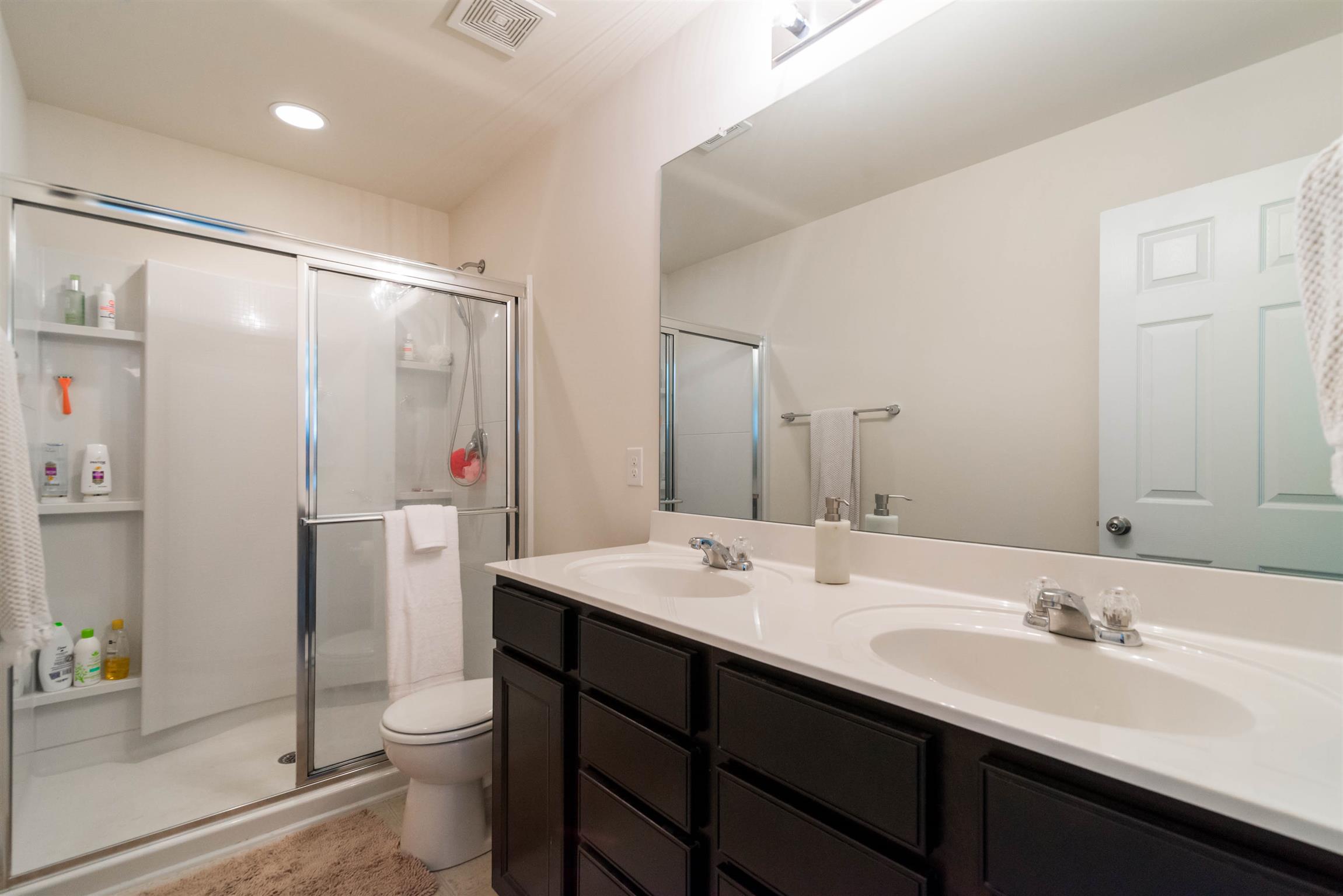 1448 Old Stone Road Lebanon, TN 37087 - Photo 17 of 25 a bathroom with a double vanity sink toilet and shower