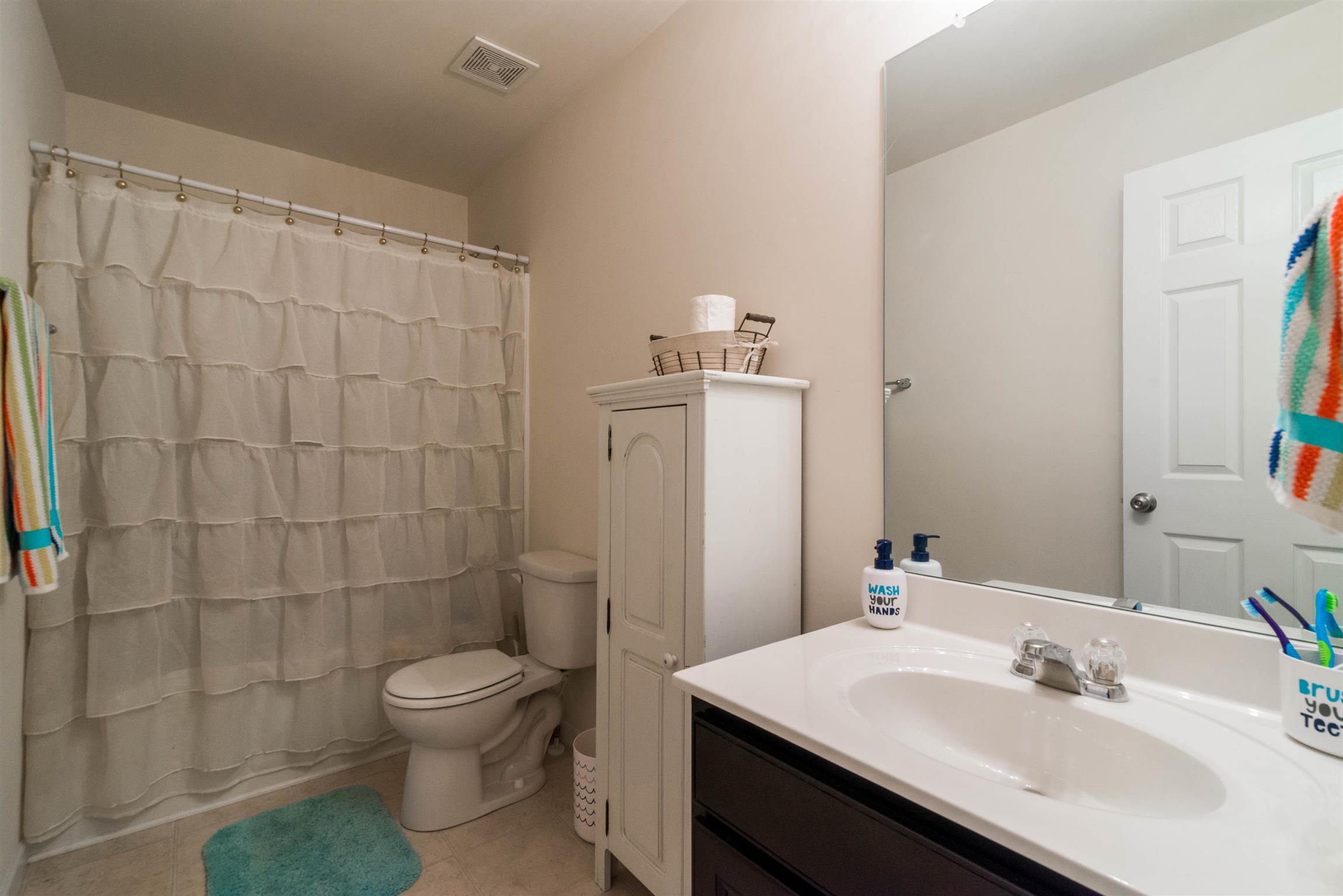 1448 Old Stone Road Lebanon, TN 37087 - Photo 20 of 25 a bathroom with a sink toilet and shower
