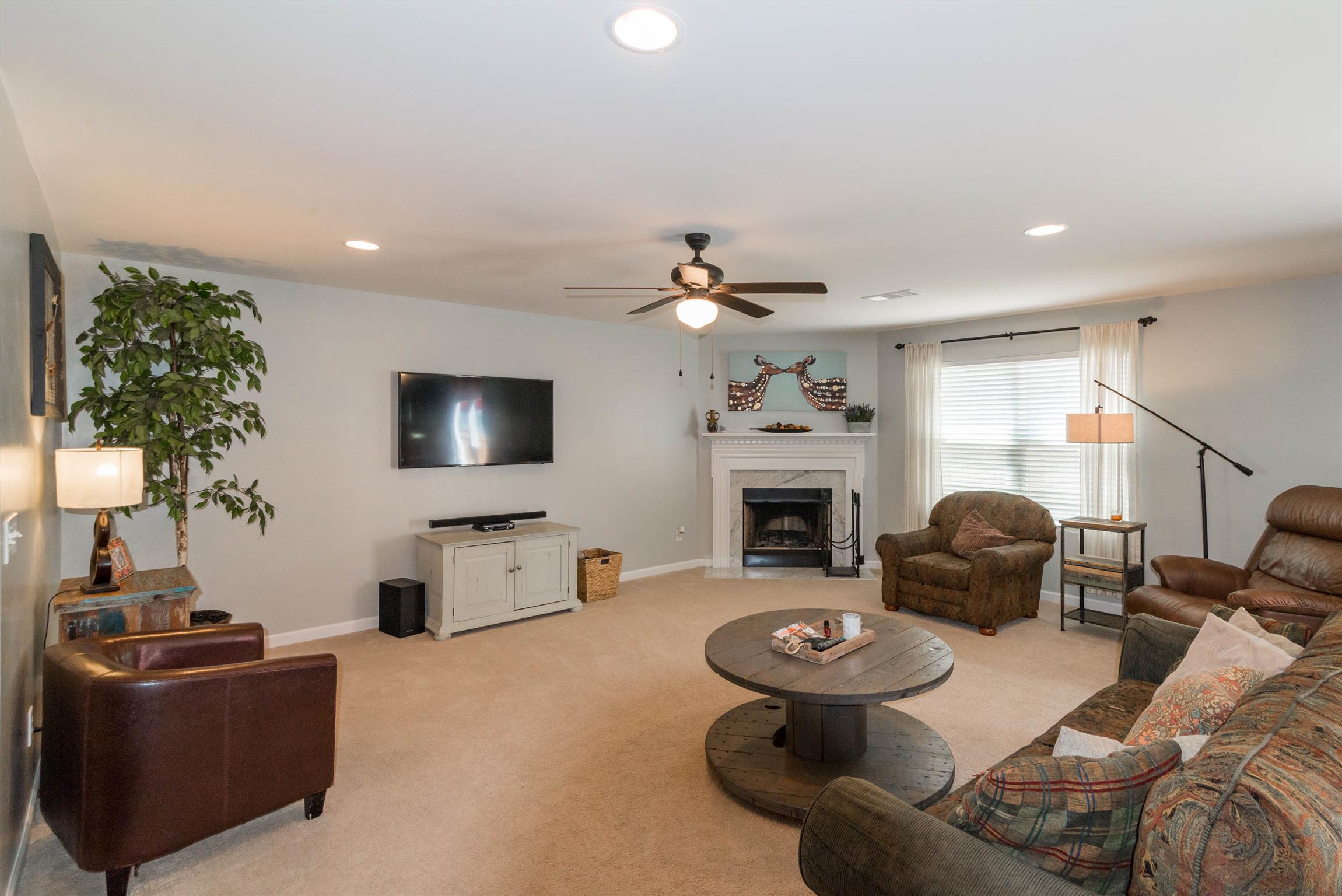 1448 Old Stone Road Lebanon, TN 37087 - Photo 6 of 25 a living room with furniture a fireplace and a flat screen tv