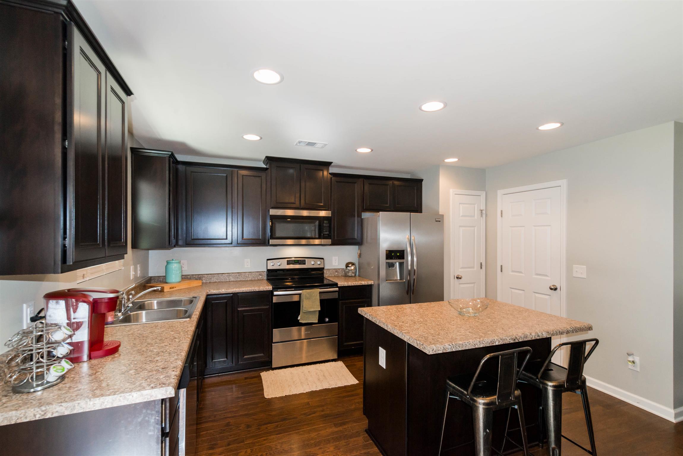 1448 Old Stone Road Lebanon, TN 37087 - Photo 10 of 25 a kitchen with stainless steel appliances granite countertop a sink dishwasher a refrigerator and a stove