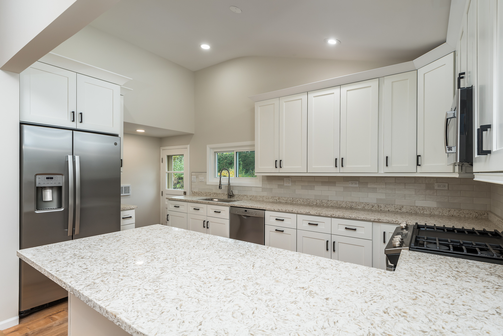 310 Voltz Road Northbrook, IL 60062 - Photo 3 of 18 a kitchen with stainless steel appliances granite countertop a sink refrigerator and cabinets