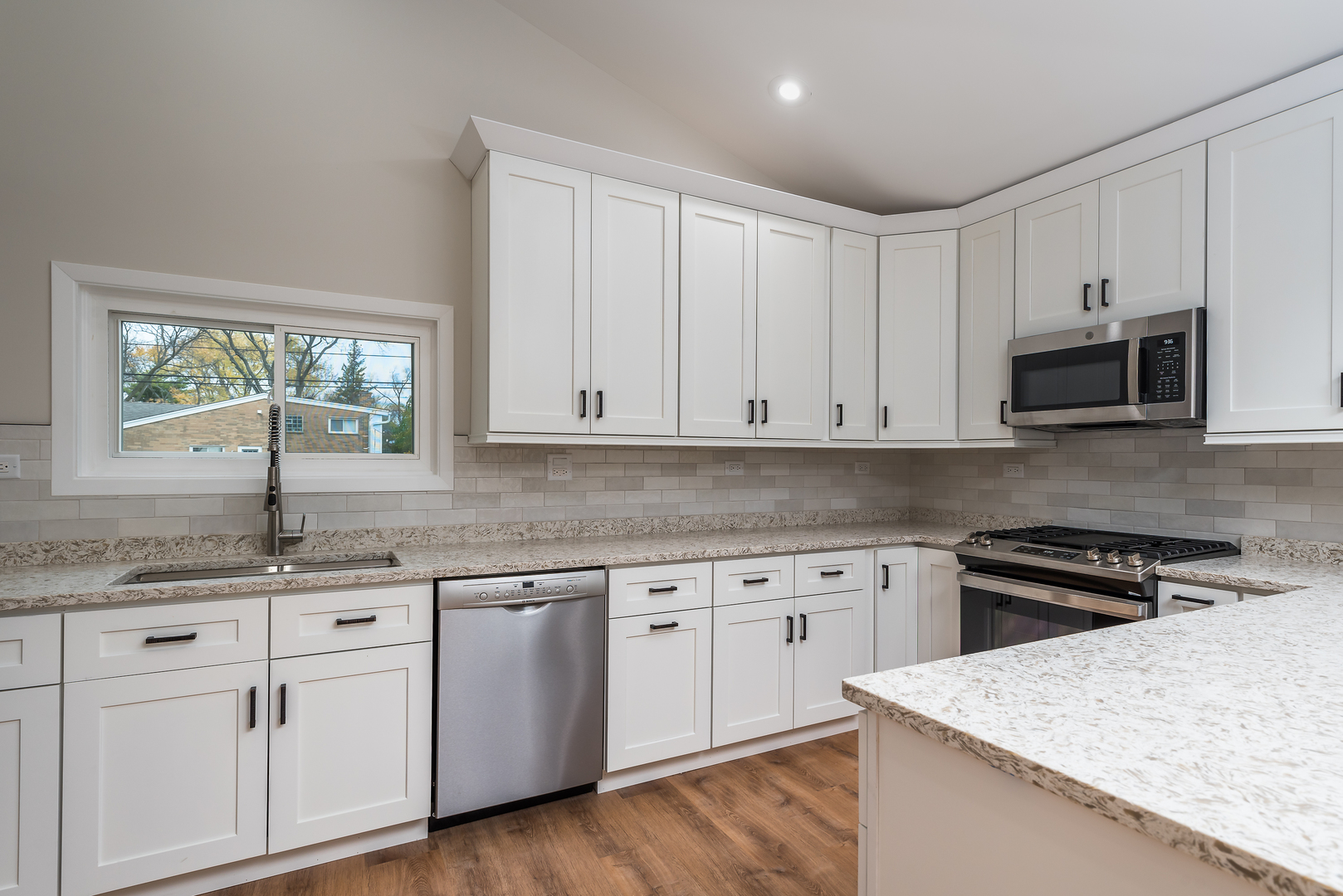 310 Voltz Road Northbrook, IL 60062 - Photo 5 of 18 a kitchen with white cabinets appliances and a window