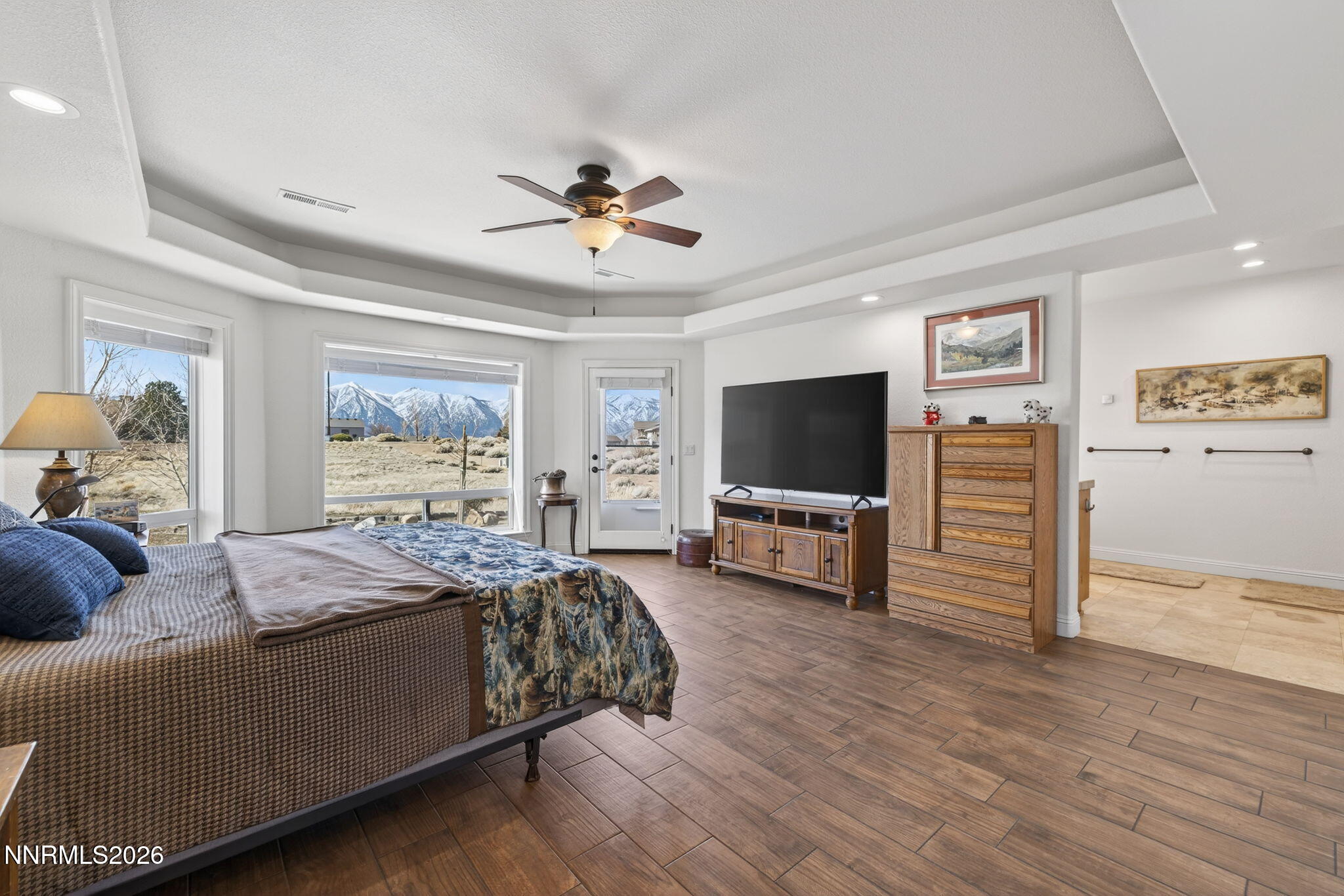 1720 North Benton Road Minden, NV 89423 - Photo 17 of 46 a spacious bedroom with a bed and a flat screen tv