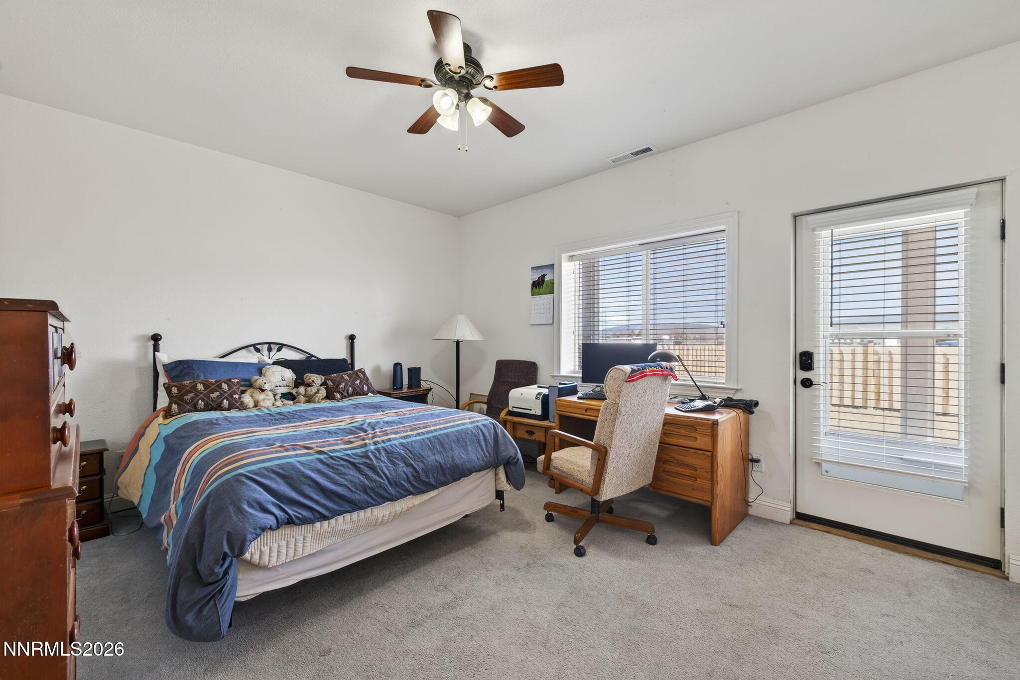 1720 North Benton Road Minden, NV 89423 - Photo 31 of 46 a spacious bedroom with a bed a chandelier and a couch