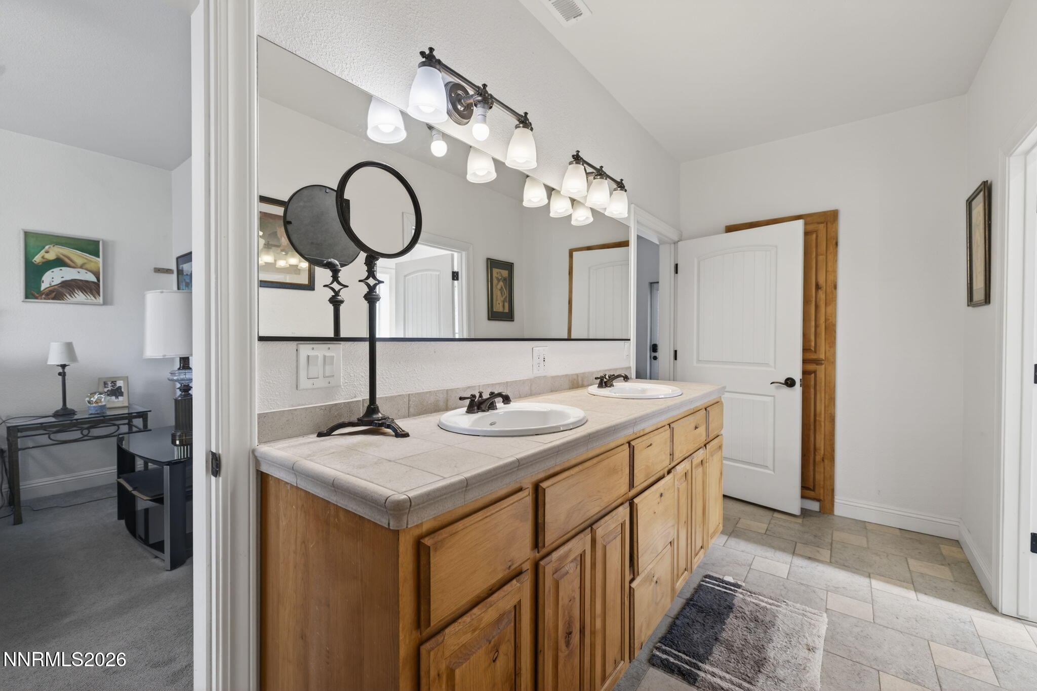 1720 North Benton Road Minden, NV 89423 - Photo 33 of 46 a bathroom with a double vanity sink and a mirror
