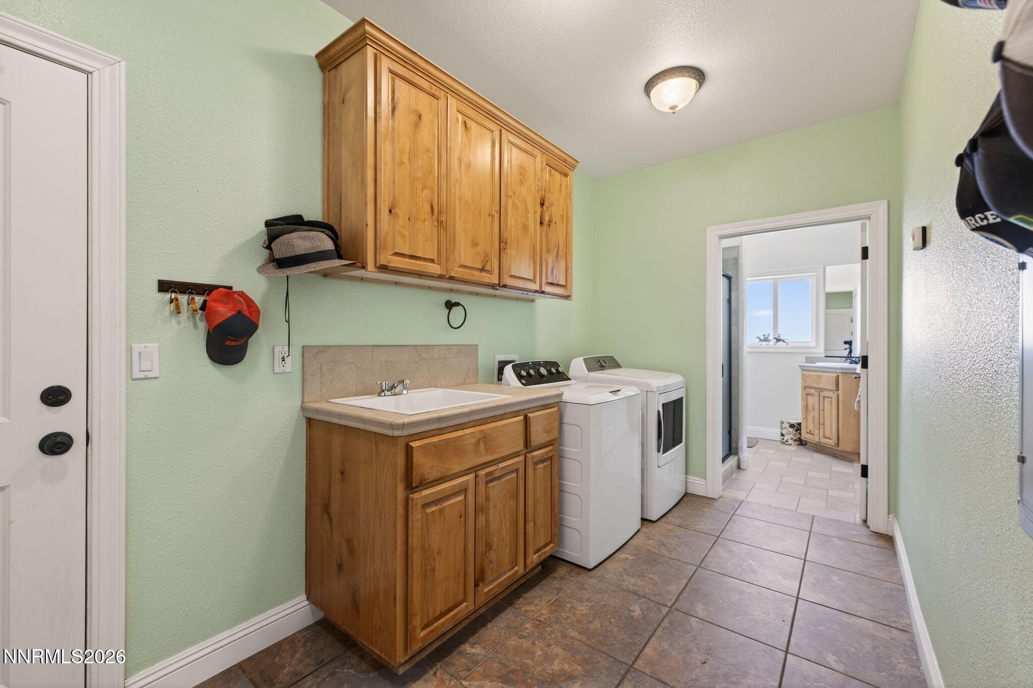 1720 North Benton Road Minden, NV 89423 - Photo 35 of 46 a utility room with cabinets dryer and washer