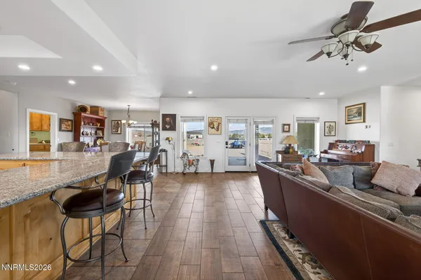 a spacious bedroom with a bed and a flat screen tv