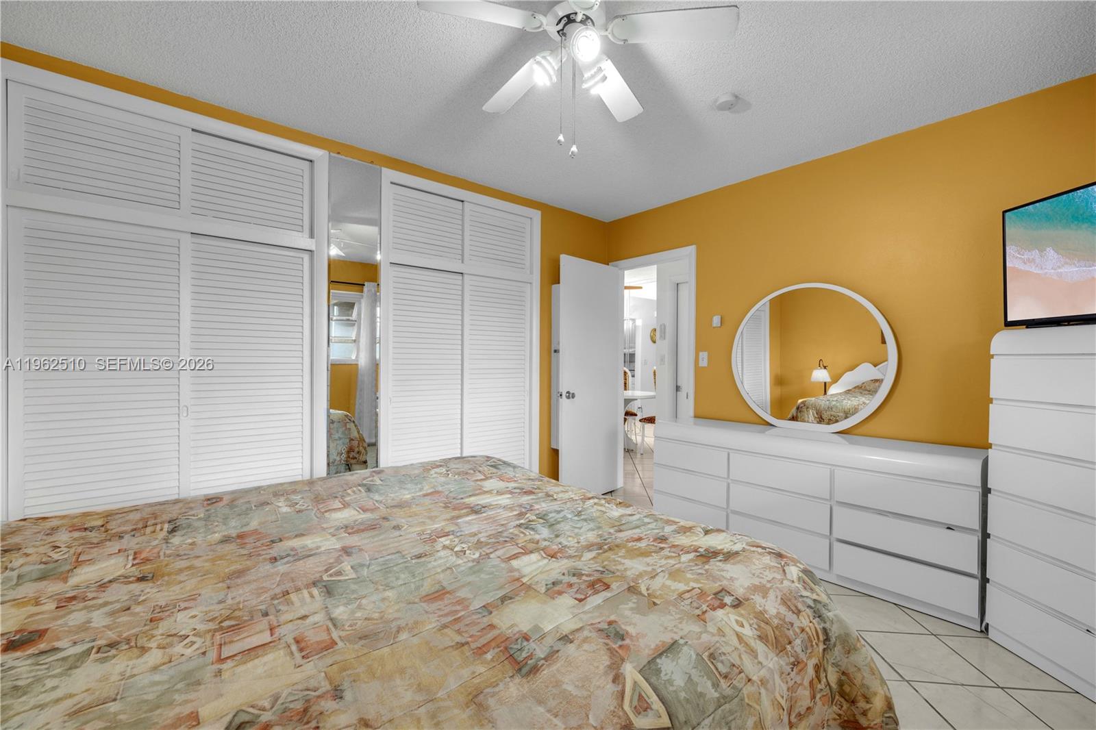 16750 Northeast 14th Avenue, Unit 308 Miami, FL 33162 - Photo 11 of 29 a bedroom with a bed and a dresser