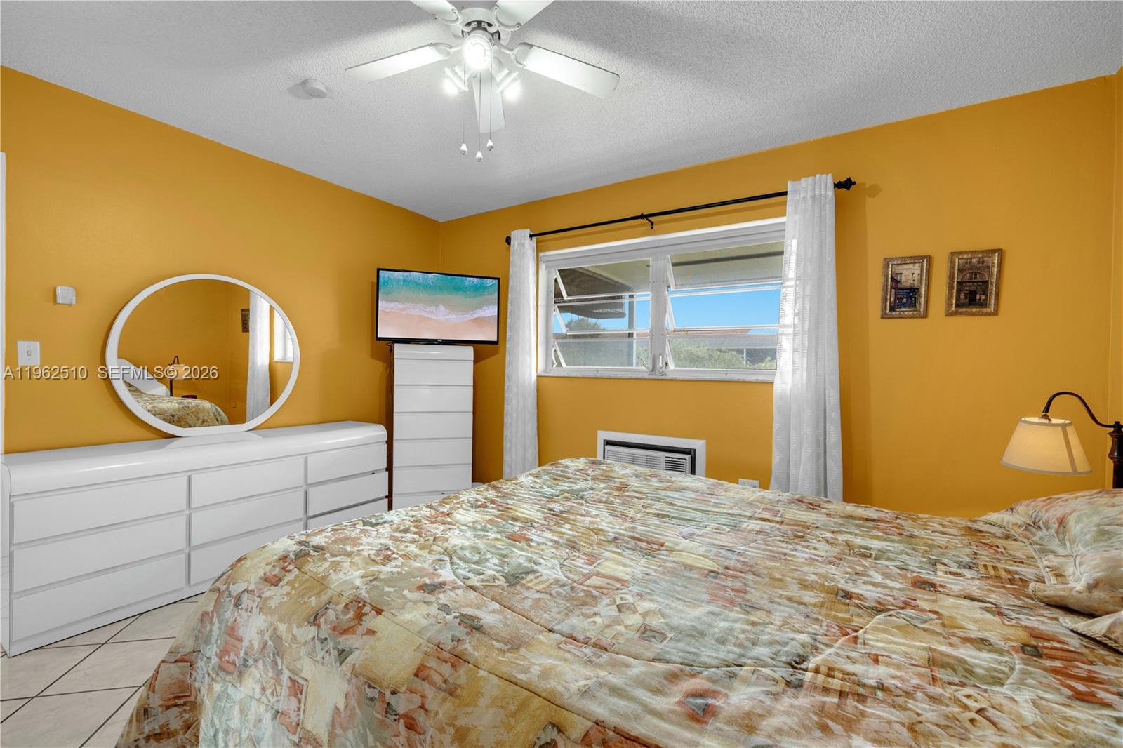 16750 Northeast 14th Avenue, Unit 308 Miami, FL 33162 - Photo 12 of 29 a bedroom with a bed and a dresser