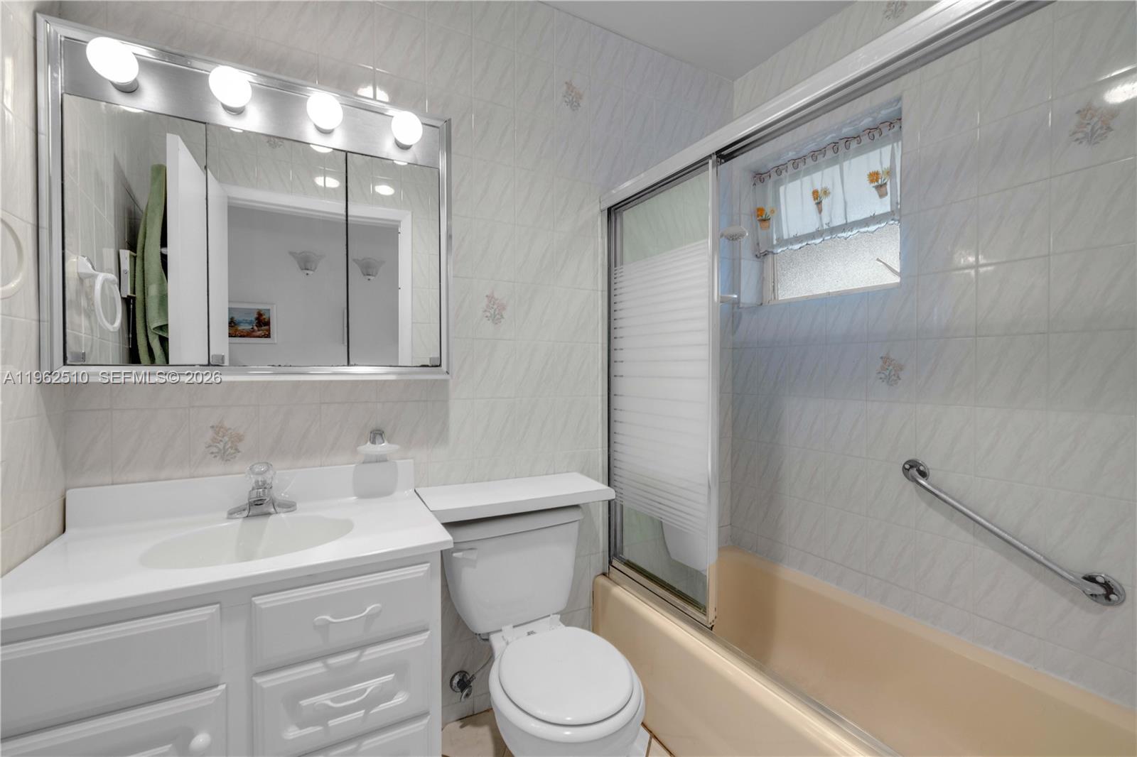 16750 Northeast 14th Avenue, Unit 308 Miami, FL 33162 - Photo 13 of 29 a bathroom with a sink a toilet and shower