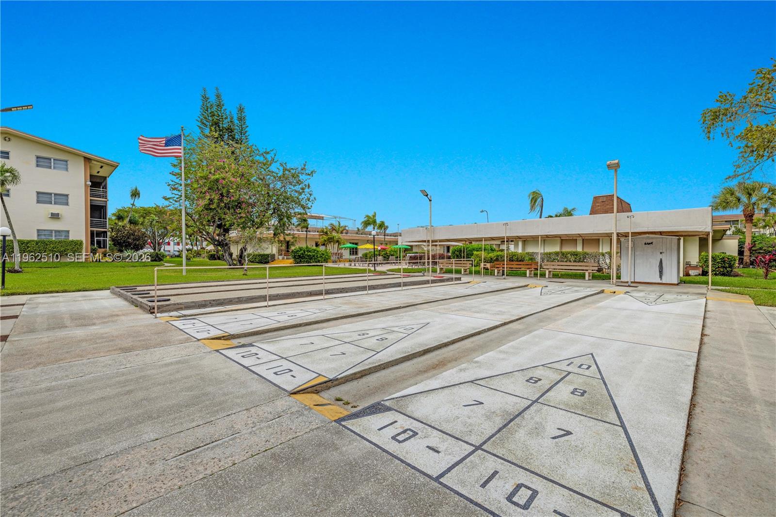 16750 Northeast 14th Avenue, Unit 308 Miami, FL 33162 - Photo 18 of 29 a view of a swimming pool with a yard and plants
