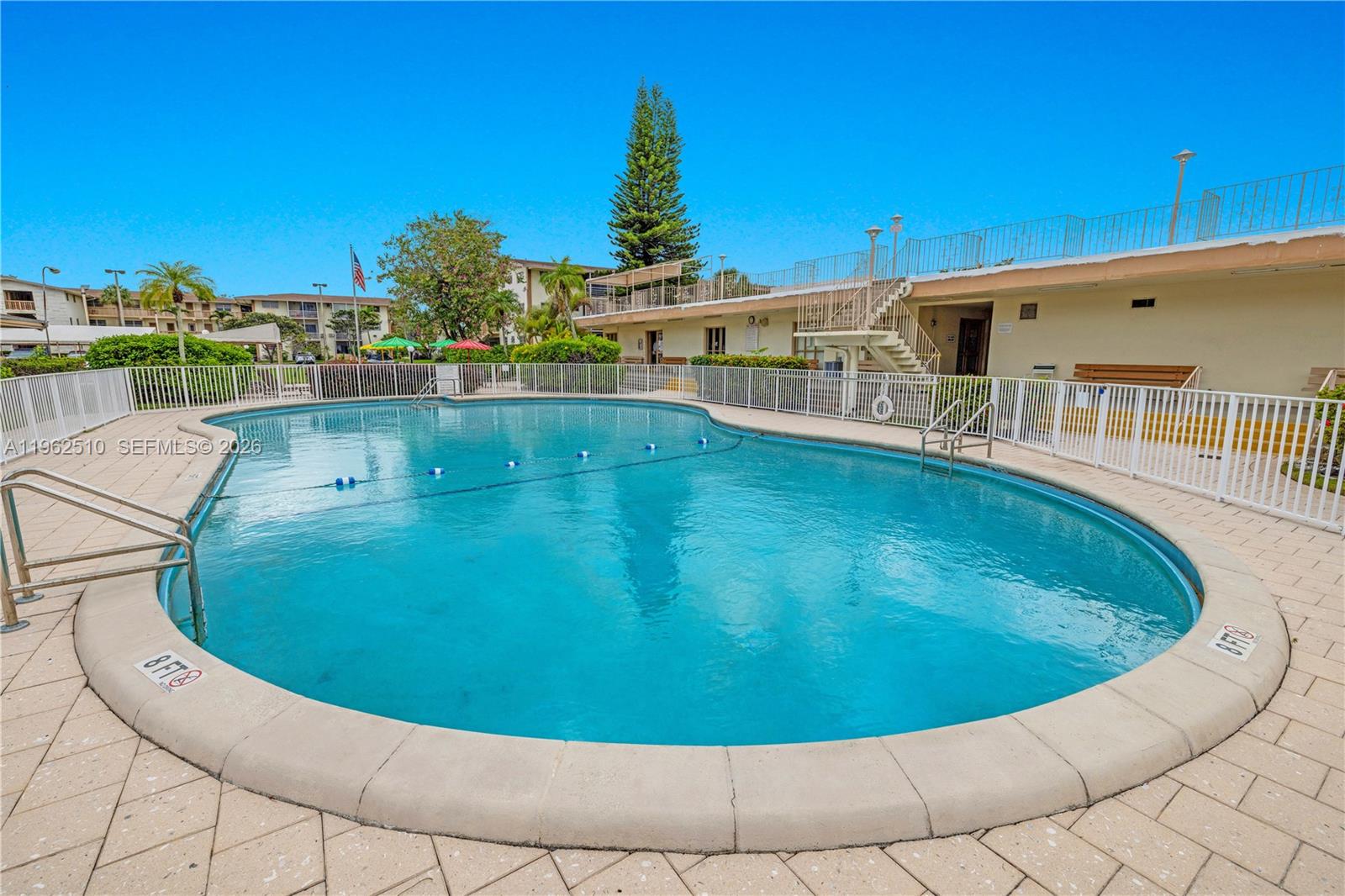16750 Northeast 14th Avenue, Unit 308 Miami, FL 33162 - Photo 21 of 29 a view of a swimming pool with an outdoor seating