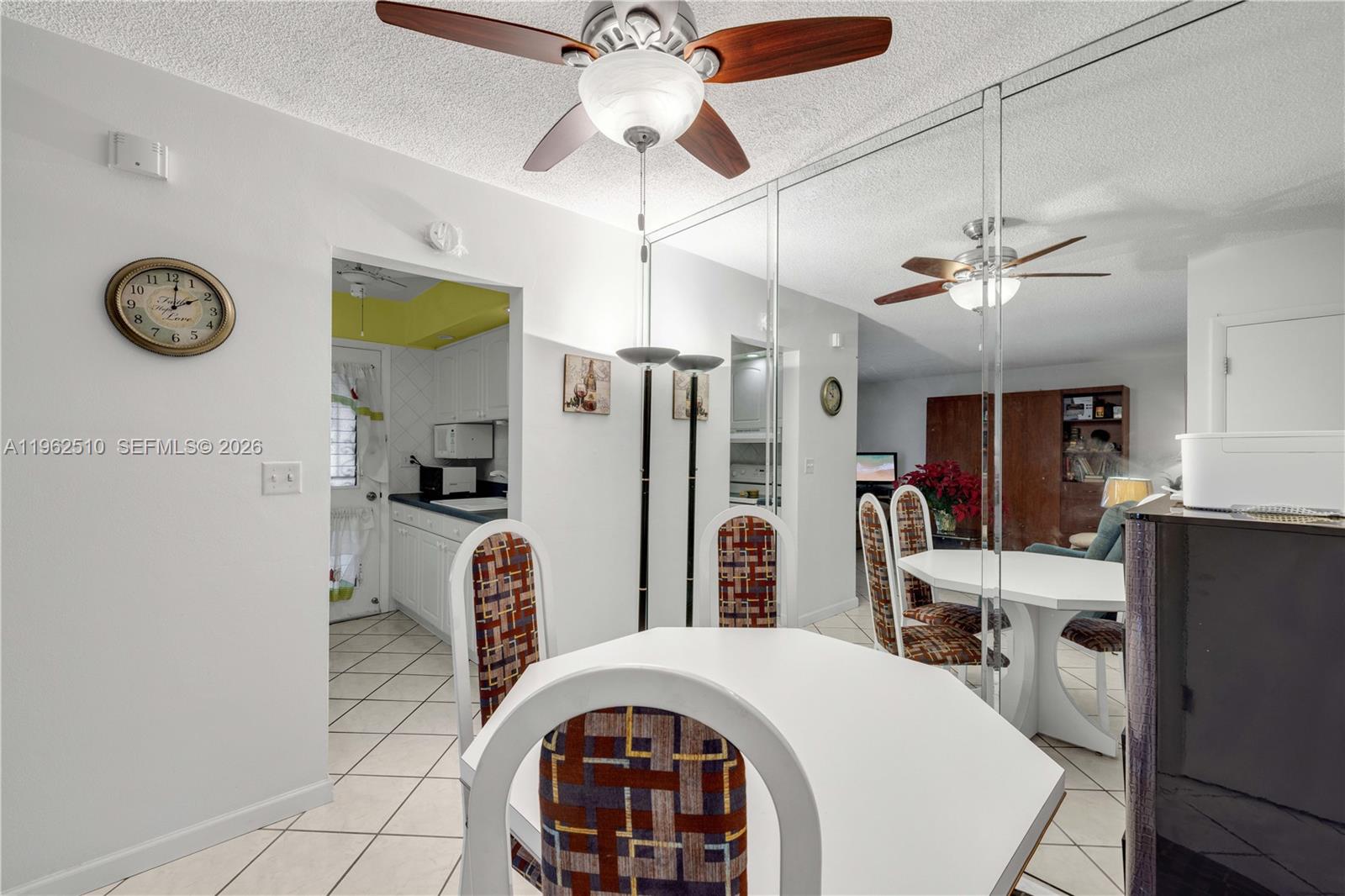 16750 Northeast 14th Avenue, Unit 308 Miami, FL 33162 - Photo 7 of 29 a very nice looking open kitchen with stainless steel appliances granite countertop a stove a refrigerator and a chandelier