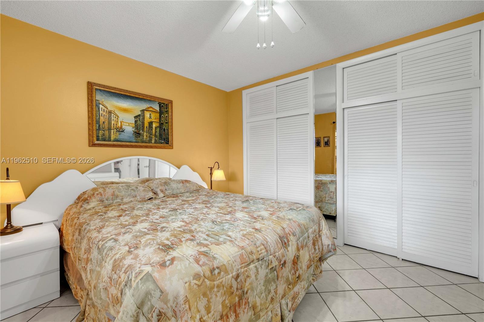 16750 Northeast 14th Avenue, Unit 308 Miami, FL 33162 - Photo 10 of 29 a bedroom with a bed and a painting on the wall