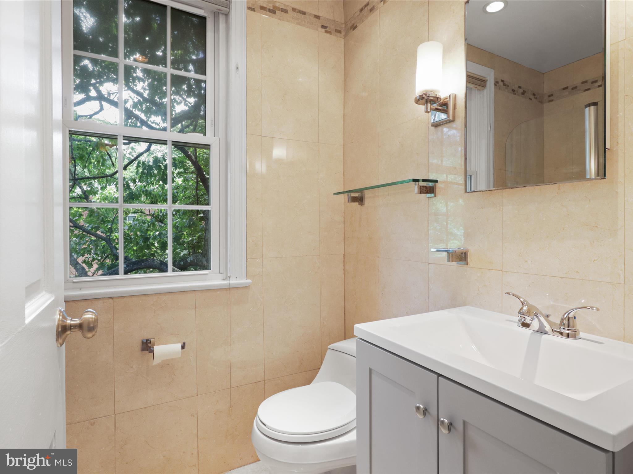 2721 Ordway Street Northwest, Unit 5 Washington, DC 20008 - Photo 12 of 39 a bathroom with a sink a toilet and shower