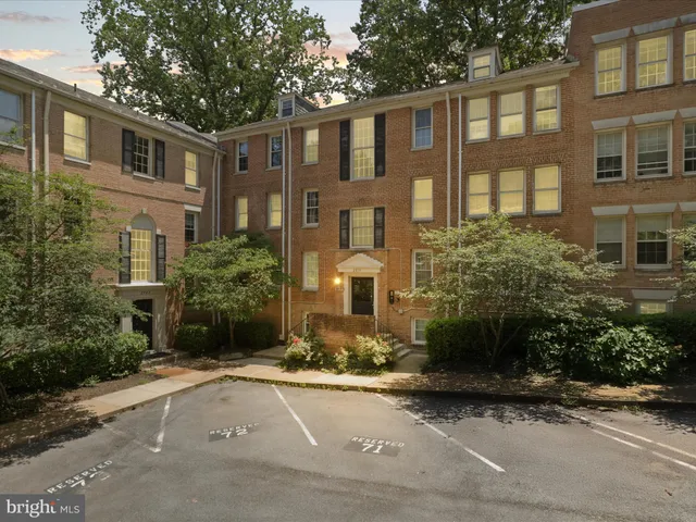 a front view of a residential apartment building with a yard