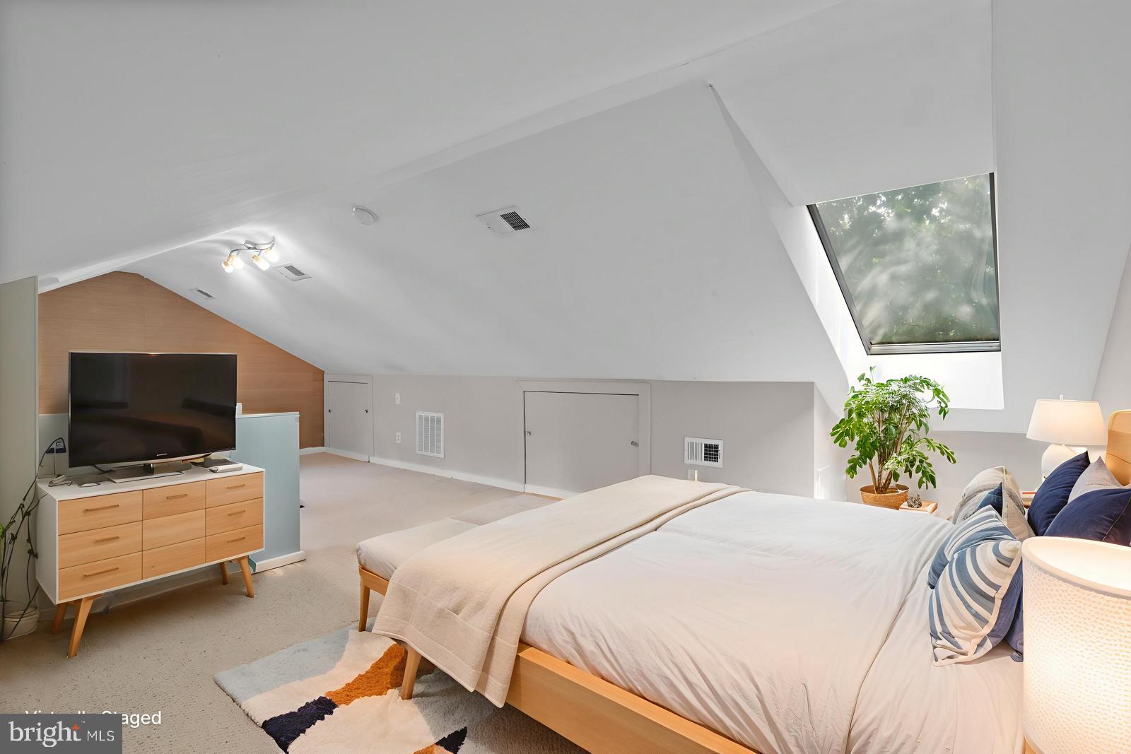 2721 Ordway Street Northwest, Unit 5 Washington, DC 20008 - Photo 23 of 39 a bedroom with a bed and flat screen tv