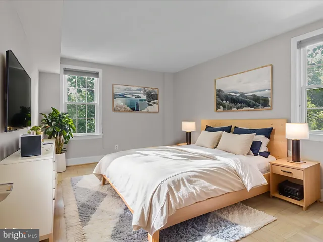 a bedroom with bed and a potted plant