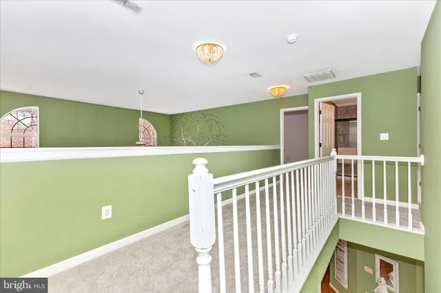 a spacious bathroom with a bathtub sink and mirror