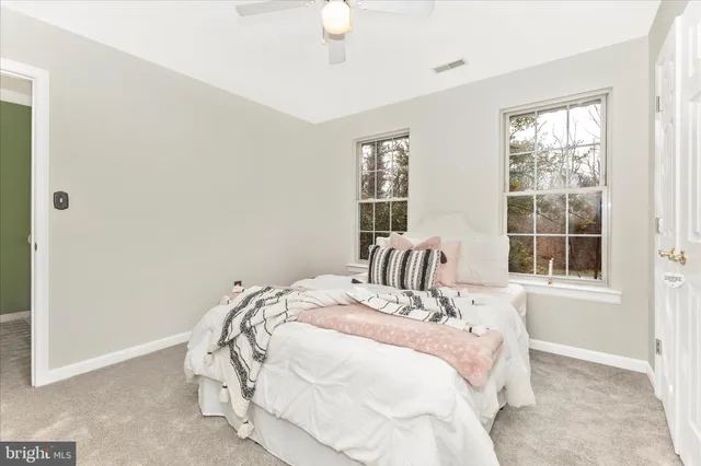 a view of a patio with a dining table and chairs under an umbrella
