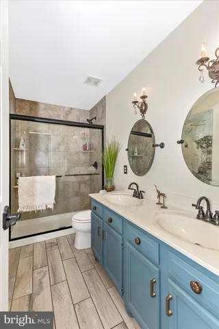 a front view of a house with a yard covered with trees