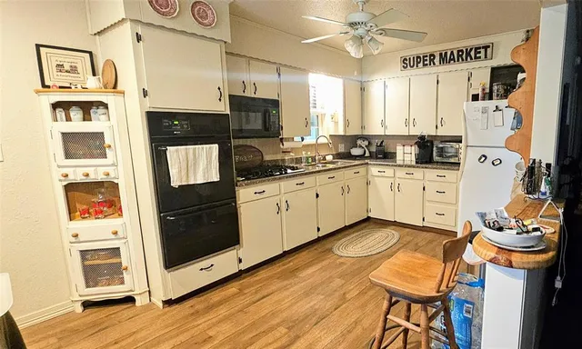 a kitchen with stainless steel appliances granite countertop a stove and a refrigerator