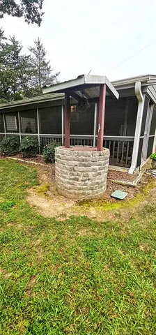 a view of a house with a backyard and a patio