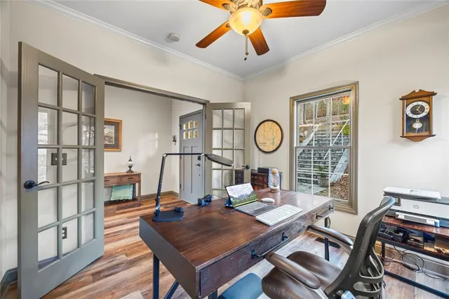 a kitchen with stainless steel appliances granite countertop a table chairs sink and cabinets