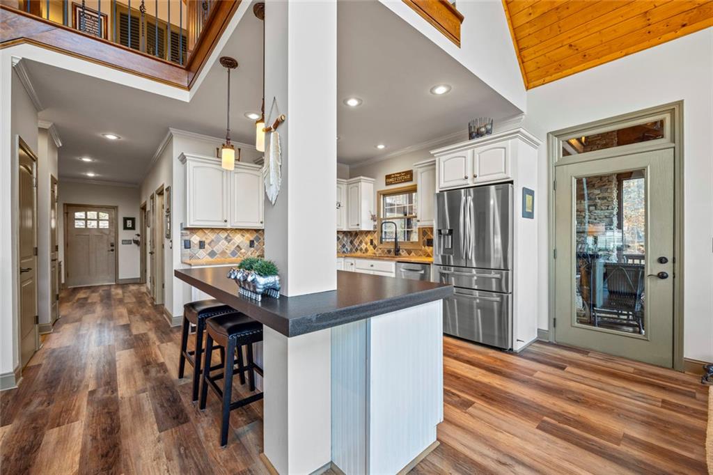 152 Chapman Manor Drive Martin, GA 30557 - Photo 27 of 90 a kitchen with stainless steel appliances kitchen island wooden floors refrigerator and dining table