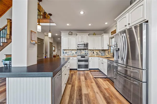a view of a patio with table and chairs with wooden fence