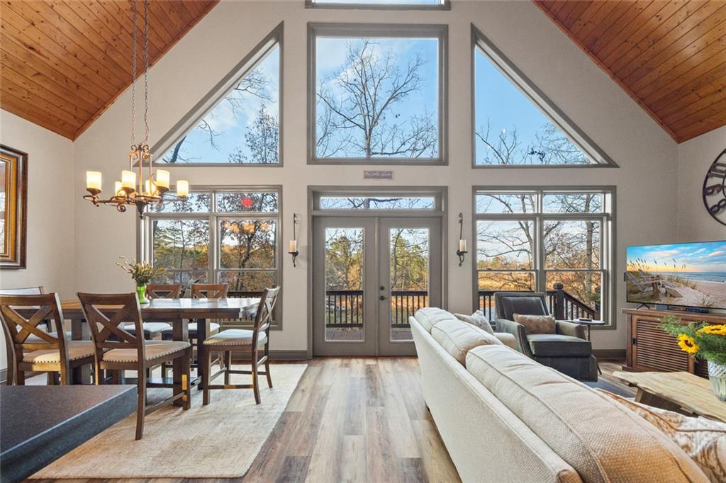 152 Chapman Manor Drive Martin, GA 30557 - Photo 33 of 90 a living room with furniture a chandelier and large windows
