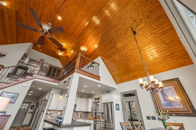 a living room with furniture a chandelier and a dining table