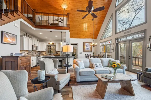 a bedroom with a large bed and a chandelier