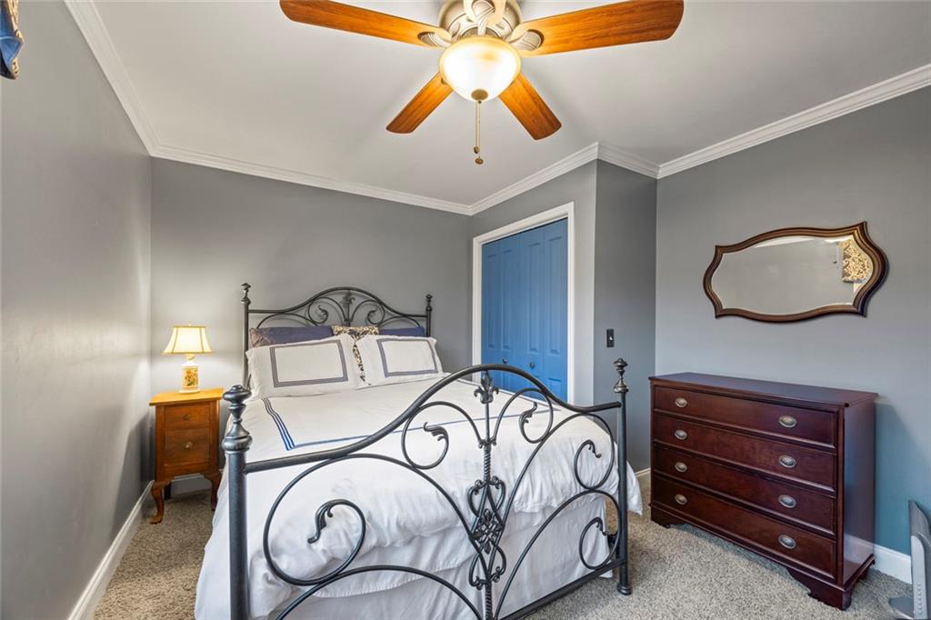 152 Chapman Manor Drive Martin, GA 30557 - Photo 60 of 90 a bedroom with a bed and a chandelier