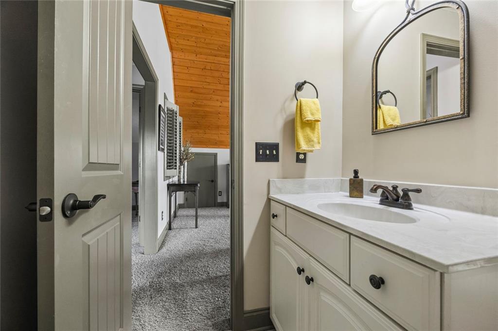 152 Chapman Manor Drive Martin, GA 30557 - Photo 63 of 90 a bathroom with a granite countertop sink and a mirror