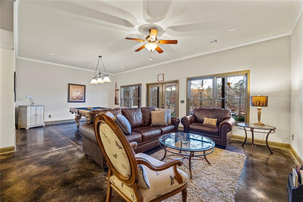 152 Chapman Manor Drive Martin, GA 30557 - Photo 67 of 90 a living room with furniture a chandelier and a dining table