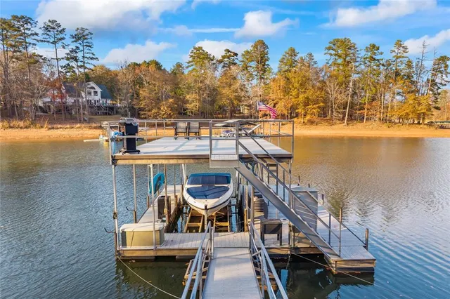 a bathroom with a granite countertop toilet sink and mirror