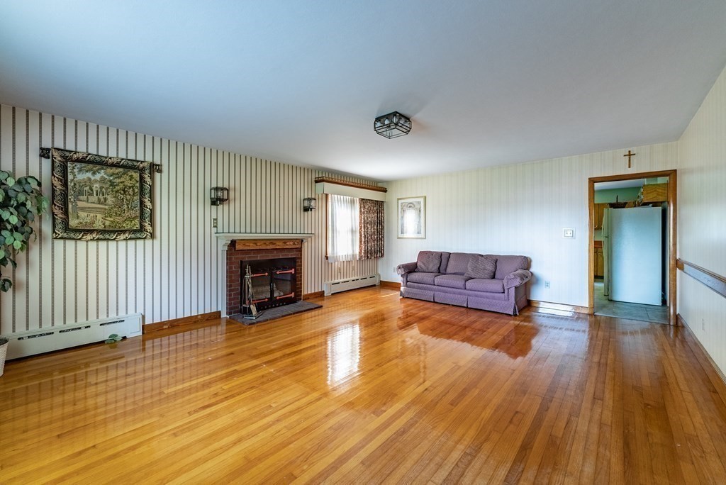 1269 Morgan Road West Springfield, MA 01089 - Photo 15 of 40 a living room with hard wood floors and a fireplace