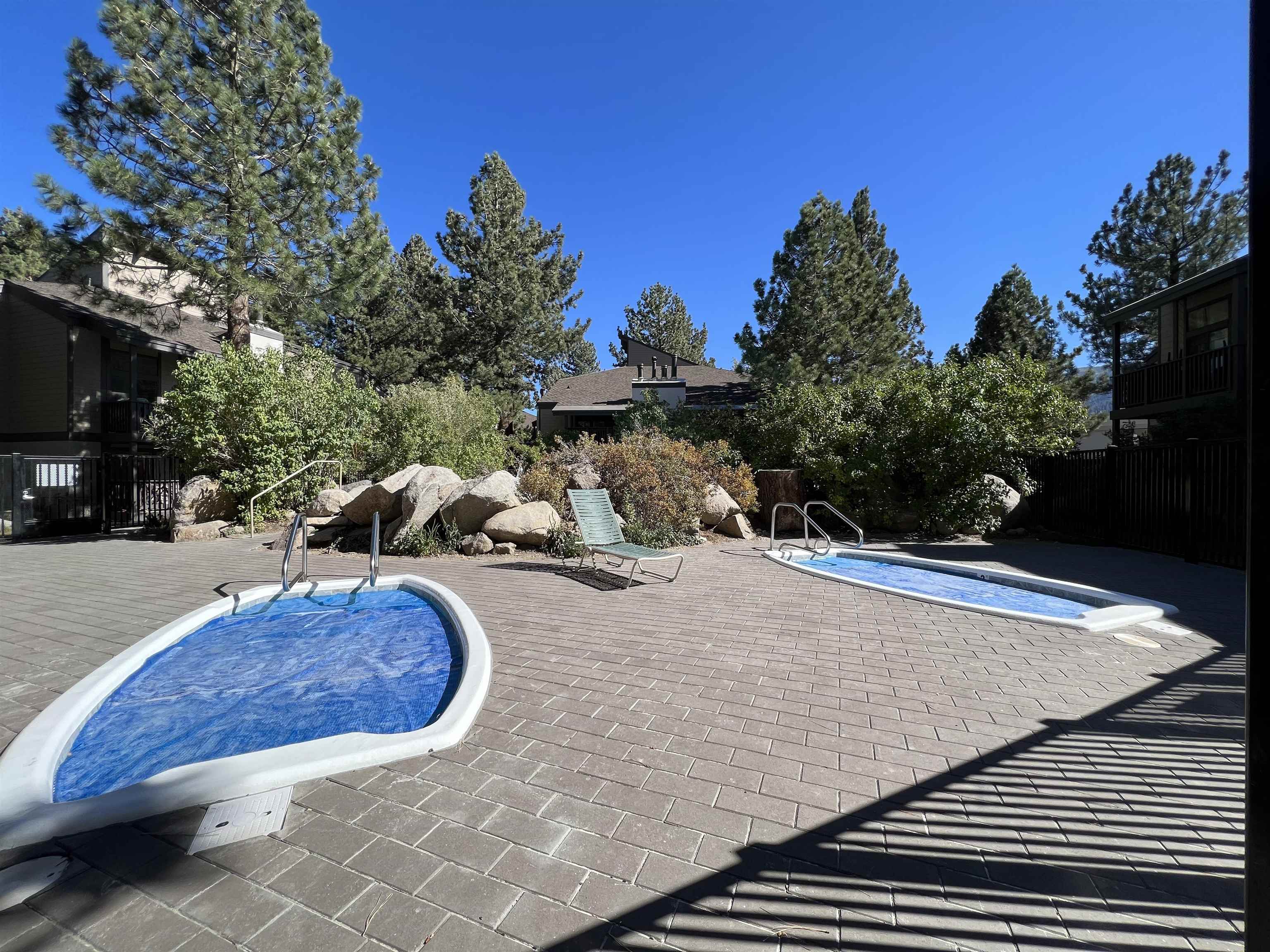 362 Old Mammoth Road, Unit 59 Mammoth Lakes, CA 93546 - Photo 33 of 35 Paver patio featuring two inground spas with protective covers