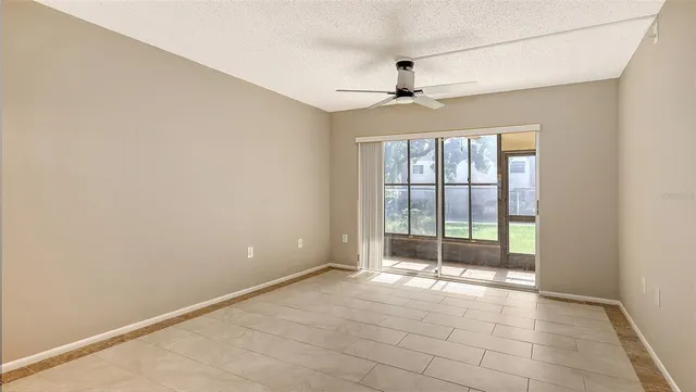 a view of an empty room with glass door