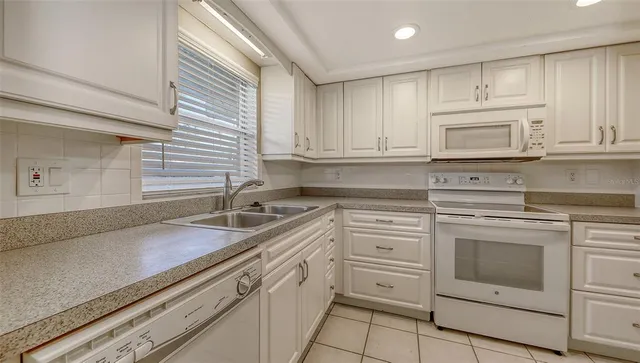a view of a glass door with a yard from a window