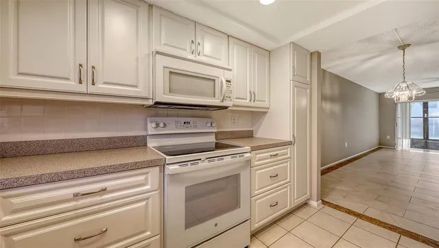a view of an empty room with wooden floor and a floor to ceiling window